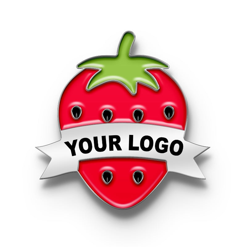 A pin with a metal clasp shaped like a strawberry with a space for a custom logo, predominantly red with a green leaf on top and a banner ribbon for personalization.