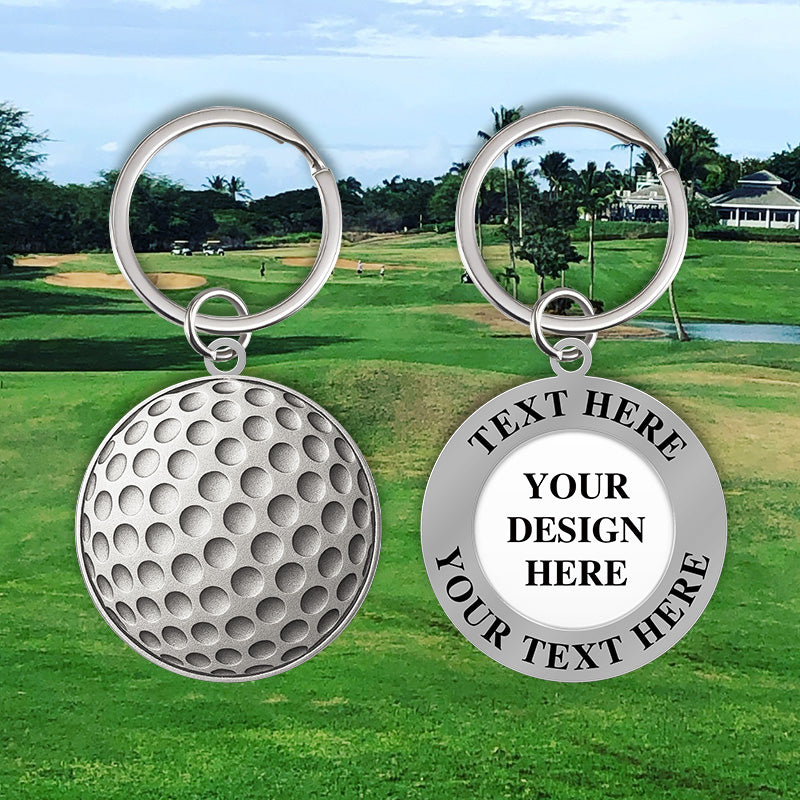 Personalized silver golf keychain showing both sides with a textured golf ball dimple design and placeholder text areas for custom text, set against a scenic golf course background to emphasize sporty customization.